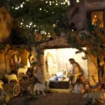 A nativity scene with a man and a baby in a manger scene