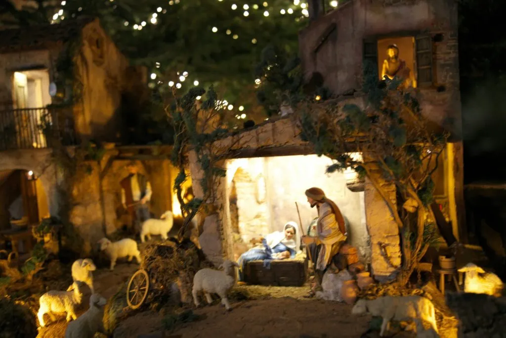 A nativity scene with a man and a baby in a manger scene