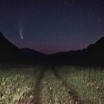 Stunning night landscape of a shooting star and field under a starry sky. Perfect for nature lovers.