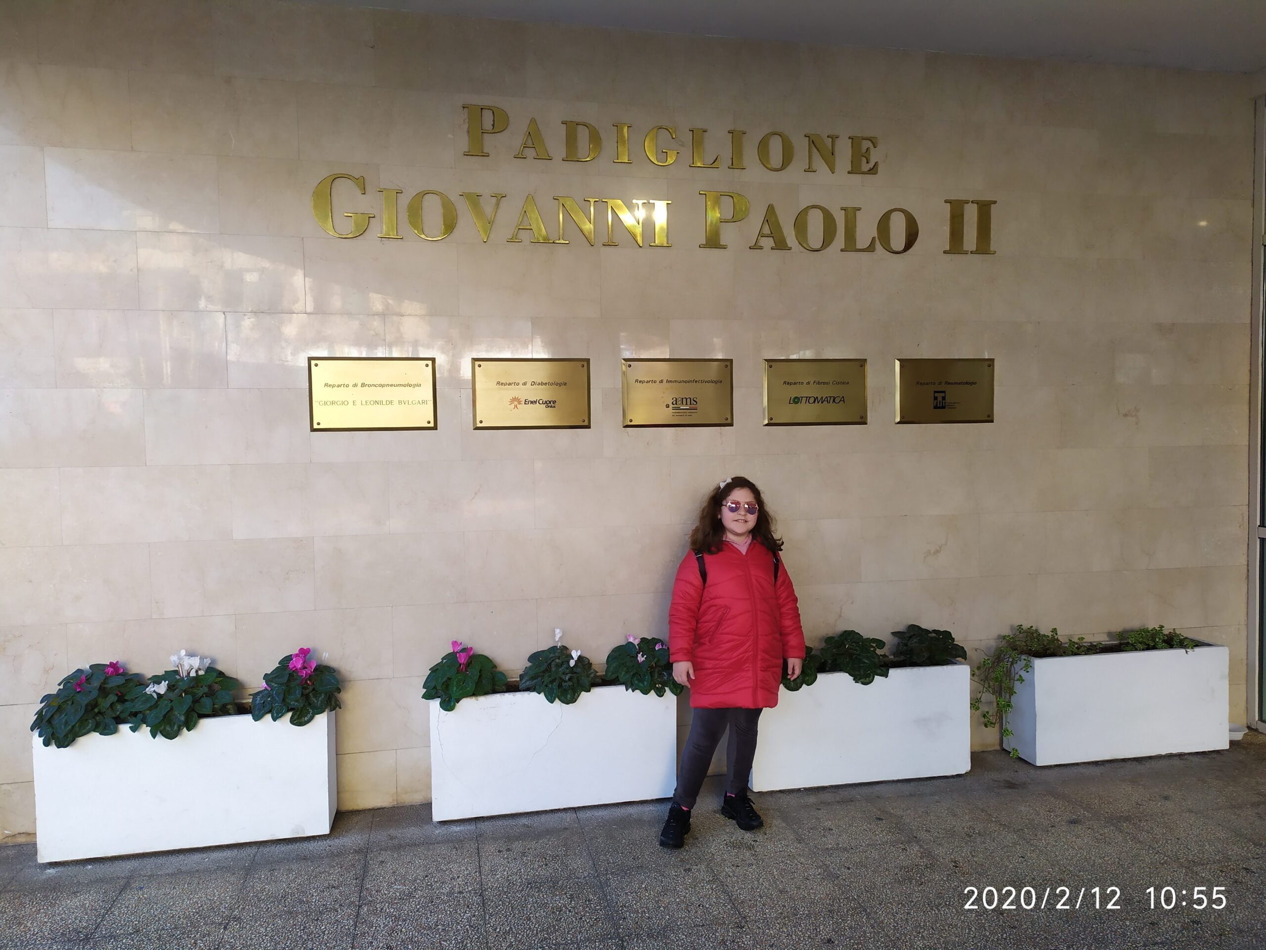 Francesca in front of the entrance to the John Paul II pavilion at OPBG